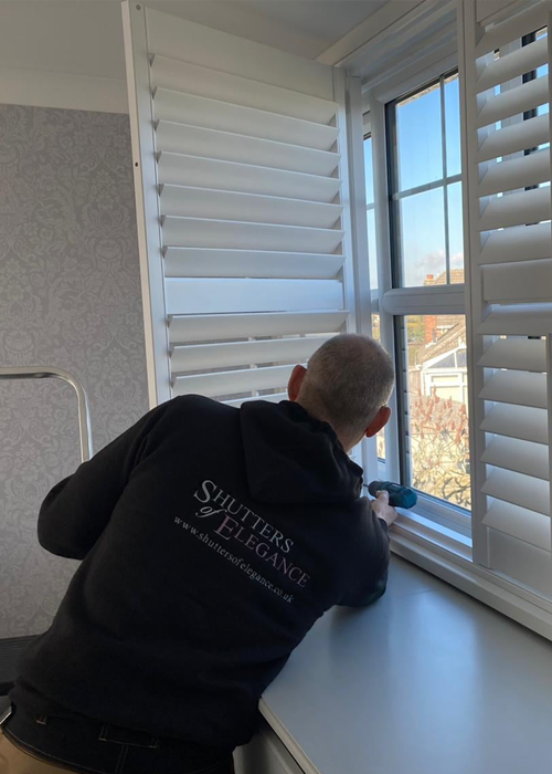 Image of our installers measuring windows for plantation shutters