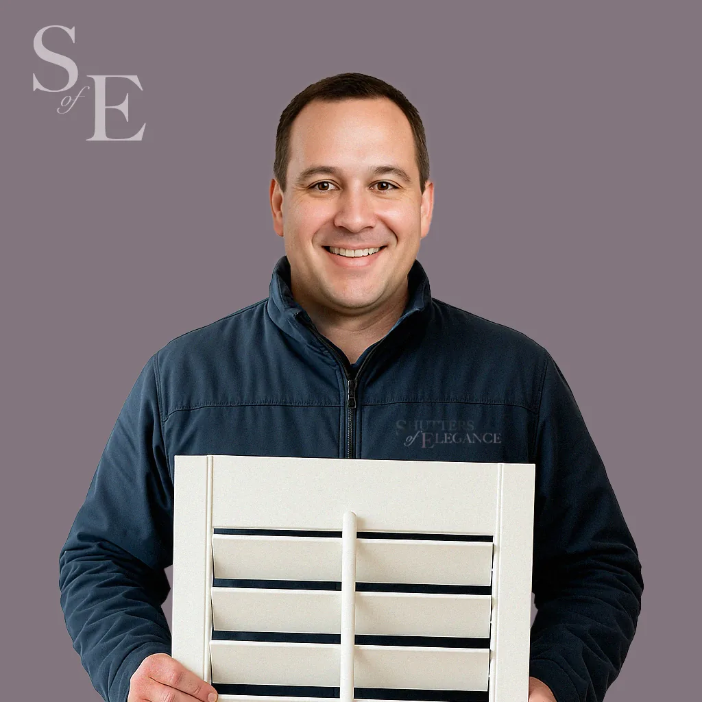 A man holding a plantation shutter panel