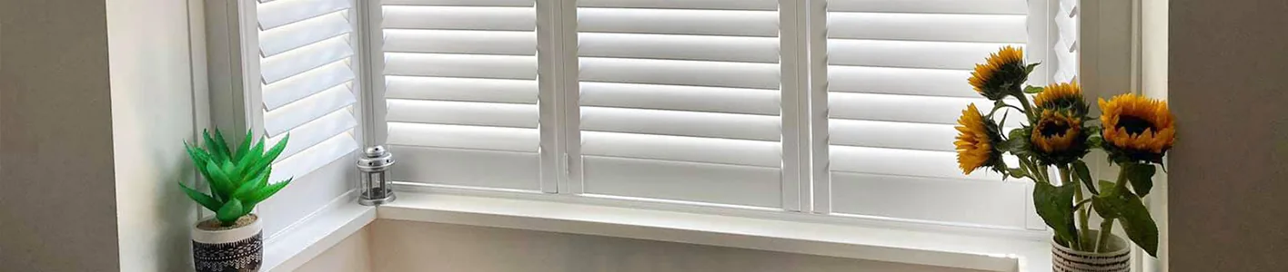 Noise-reducing plantation shutters in a calm bedroom