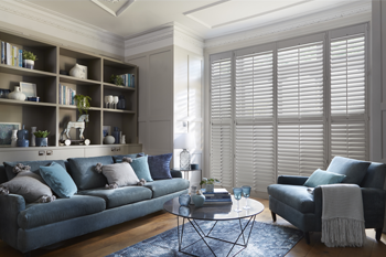 Full height window shutters in a large living room