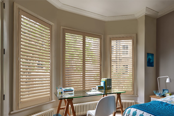 Desk under window with Shutters in home office