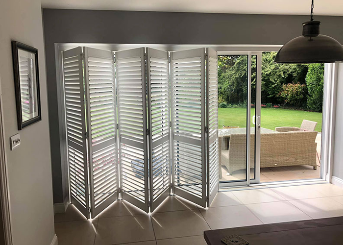 Large, full-height Worcester Shutters covering french doors