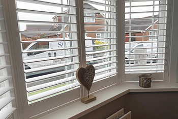 Bay window Shutter installation with our vans outside