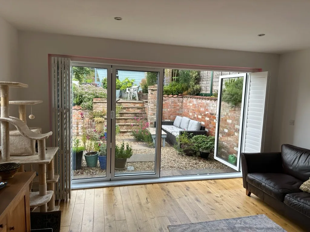 Patio door shutters slid fully clear of the opening onto the garden