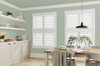 Two sets of tier-on-tier window shutters in a modern dining room