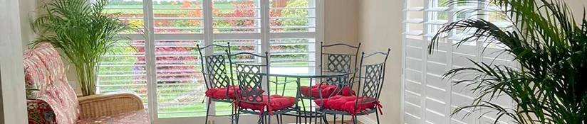 Plantation shutters keeping a sunlit room cool during a heatwave