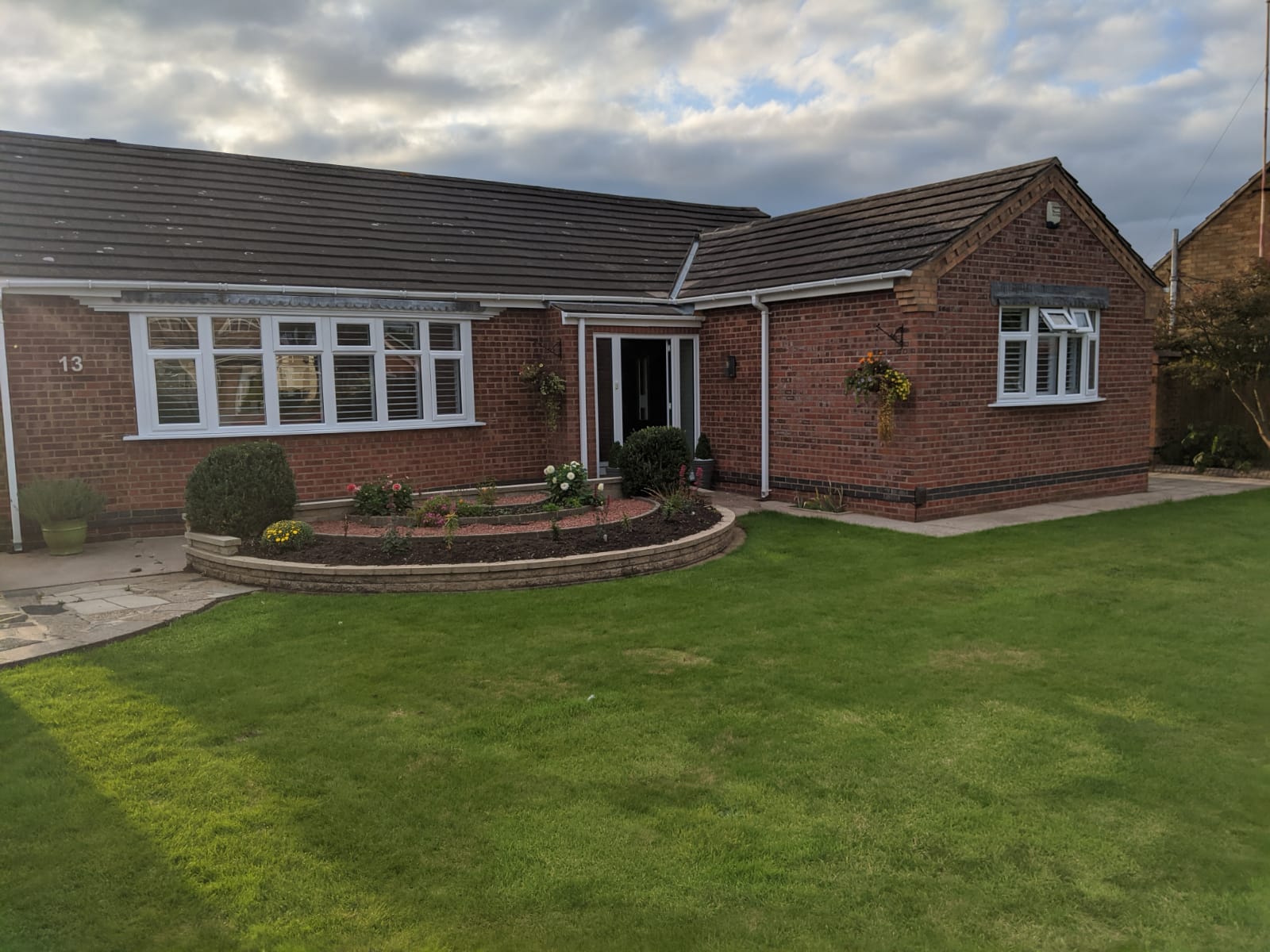 A brick house with a lawn in front of it.