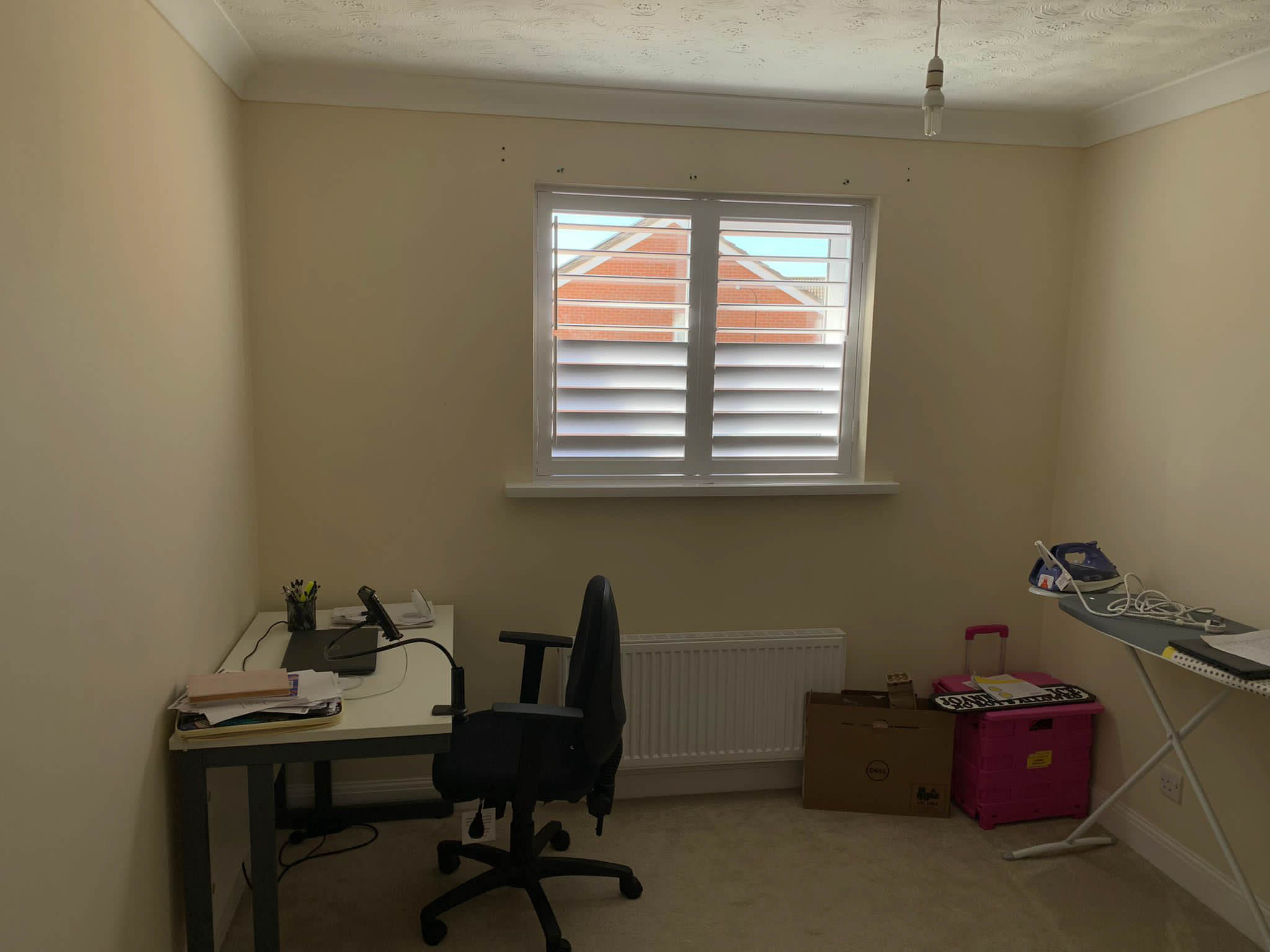 A room with a desk and a window.