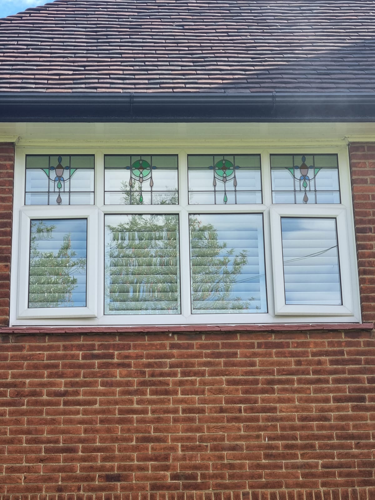 A brick house with stained glass windows.